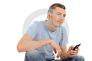 Casual young man with cell phone and headphones