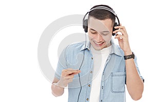 Casual young man enjoy music wearing headphones