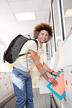 Casual young man with folders in office