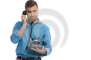 Casual young man listening to someone on the telephone