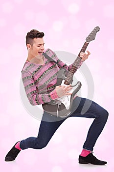 Casual young man playing a guitar