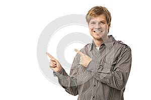 Casual young man pointing to blank space