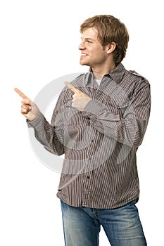 Casual young man pointing to blank space