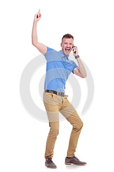 Casual young man points up while on the phone