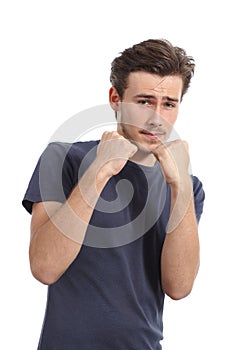 Casual young man ready to fight defending with fist up