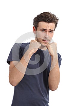 Casual young man ready to fight defending with fist up photo