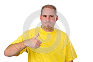 Casual young man showing thumb up