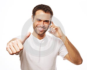 casual young man showing thumbs up sign