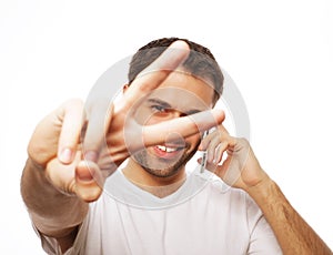 casual young man showing thumbs up sign