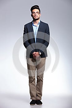Casual young man standing on gray background