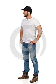 Casual Young Man Is Standing With Hands On Hip And Looking Away