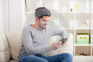 Casual young man using a tablet at home
