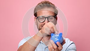 casual young man wearing polo shirt on pink background