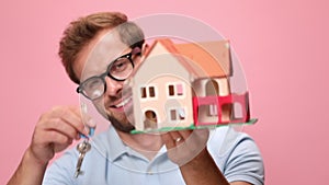 casual young man wearing polo shirt on pink background