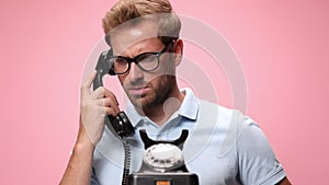 casual young man wearing polo shirt on pink background