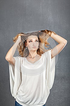 Casual young woman plaing with hair