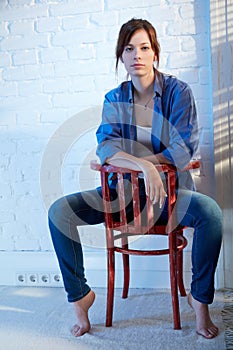 Casual young woman sitting on chair