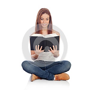 Casual young woman sitting on the floor reading a book