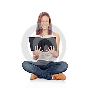 Casual young woman sitting on the floor reading a book