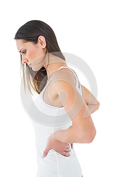 Casual young woman suffering from back pain