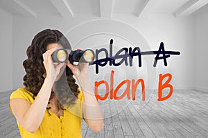 Casual young woman using binoculars