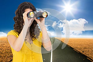 Casual young woman using binoculars