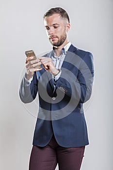 Casually dressed business man with smart mobile phone