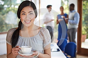 Casually Dressed Businesswoman At Meeting In Boardroom