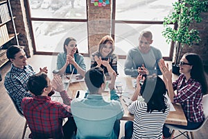 Casually dressed managers girls colleagues race brainstorming clapping approving having fun corporate wearing shirts in