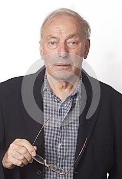 Casually dressed mature man holding glasses