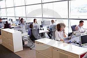 Casually dressed workers in a busy open plan office