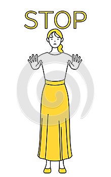 A casually dressed young woman with her hand out in front of her body, signaling a stop