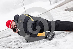 Casualty man is lying on a icy way and calling the ambulance