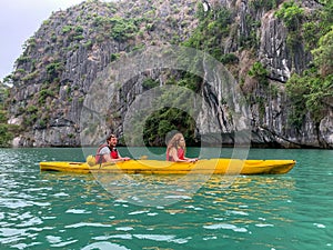 Cat Ba, Vietnam - November 19, 2019 : Caucasian couple kayaking Ha Long Bay