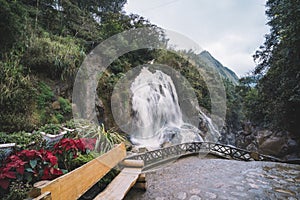 Cat Cat  village landscape with waterfall and tourists exploring the area