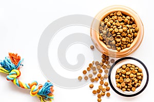 Cat and dog dry food in bowl and toys on white background top view mockup