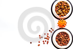 Cat and dog food in bowl on white background top view copy space