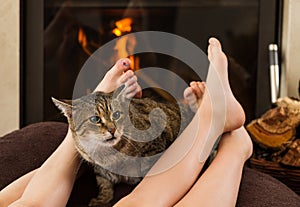 Cat and feet in front of the fireplace