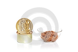 Cat food canned food in a cans on a gray background . Meat pate with pieces of meat in a glass bowl. Closed cans. Top view. Flat