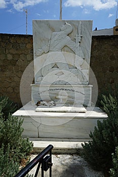 A cat lies in the shadows on a marble monument in Lardos, Rhodes Island, Greece