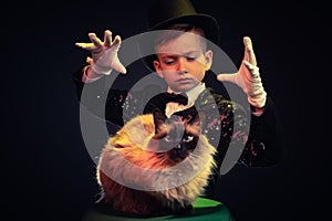 Cat and Magician kid illusionist boy in hat. costume mystery isolated black background