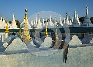 Cat sleeping on white wall of Sanda Muni Pagoda in Mandalay, Myanmar