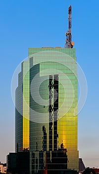 CAT Telecom building with sunset reflection on glass facades