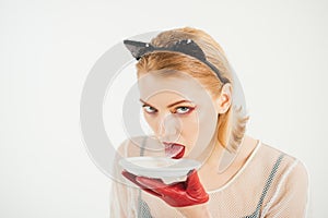 cat woman lick milk from plate. Food and drink. Dieting and health. Ecology product and heath. Cat woman eat sour