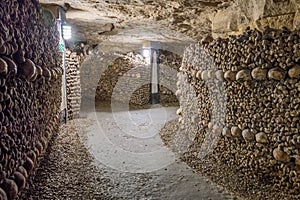 Catacombs, tunnels, walls made of bones and skulls photo