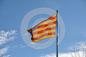Catalan Senyera flag against a blue sky