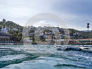 Seaside charm of Catalina Island, with boats moored in the harbor and hillside homes overlooking the Pacific