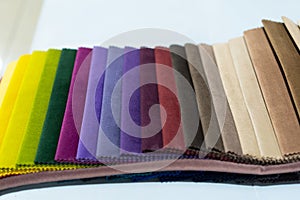 Catalog of multi-colored fabric samples. Textile industry background.