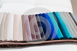 Catalog of multi-colored fabric samples. Textile industry background.