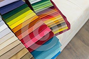 Catalog of multicolored cloth from matting fabric texture background.